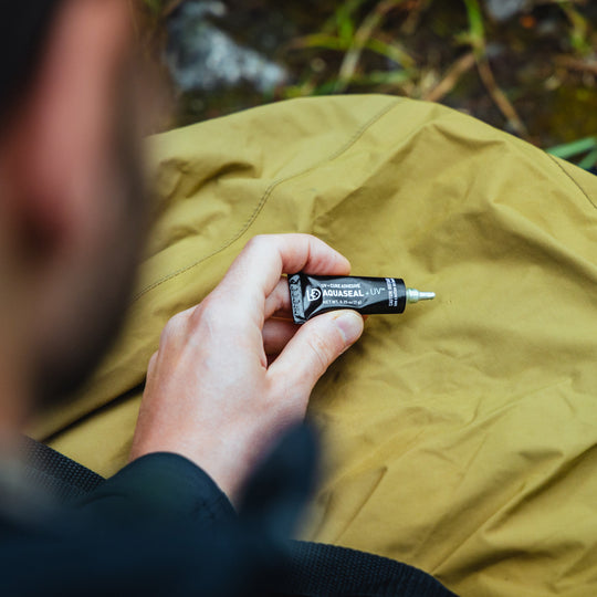 Gear Aid Aquaseal UV Field Repair Adhesive shown in use