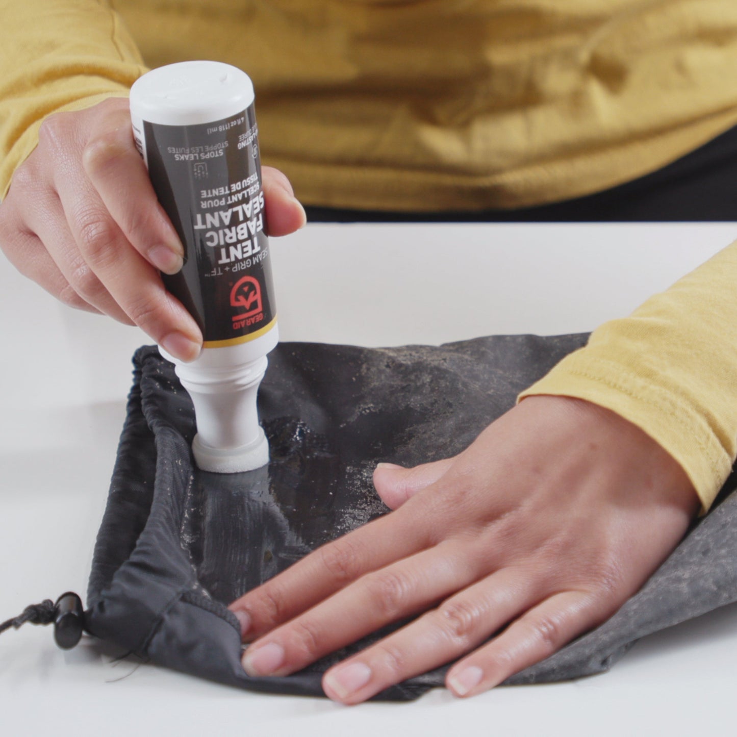 Gear Aid Seam Grip TF Tent Fabric Sealant shown in use
