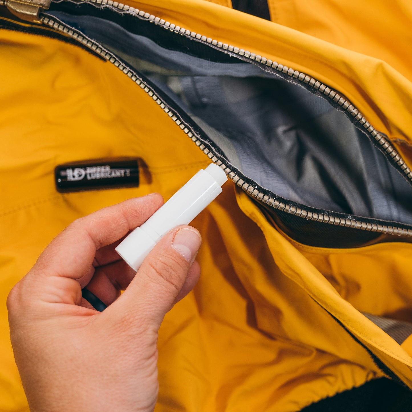 Gear Aid Zipper Lubricant Stick shown in use
