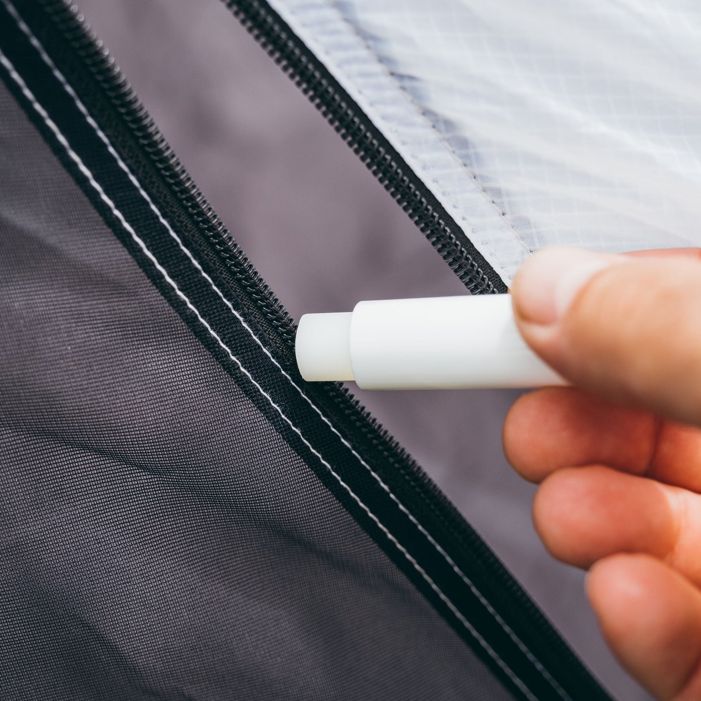 Gear Aid Zipper Lubricant Stick shown in use
