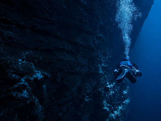 Trimix diver exploring deep technical wreck environment