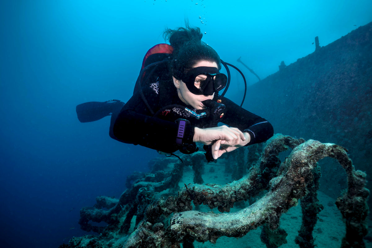 Scuba diver exploring a large submerged wreck