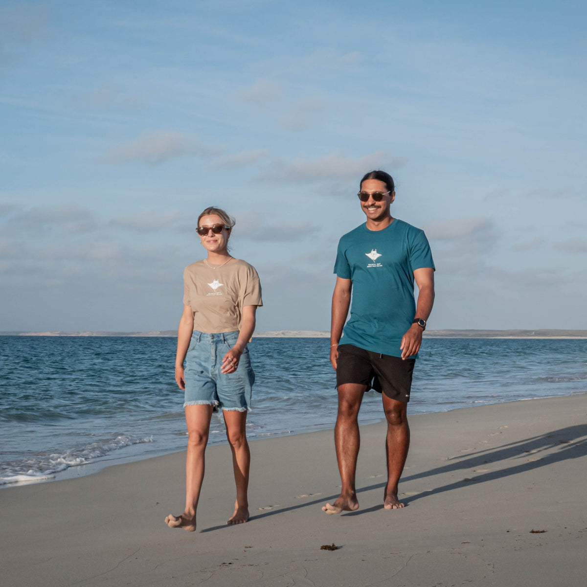 Protect What You Love Manta Ray Tee — Ocean tee worn by male model beside a model wearing a crop top
