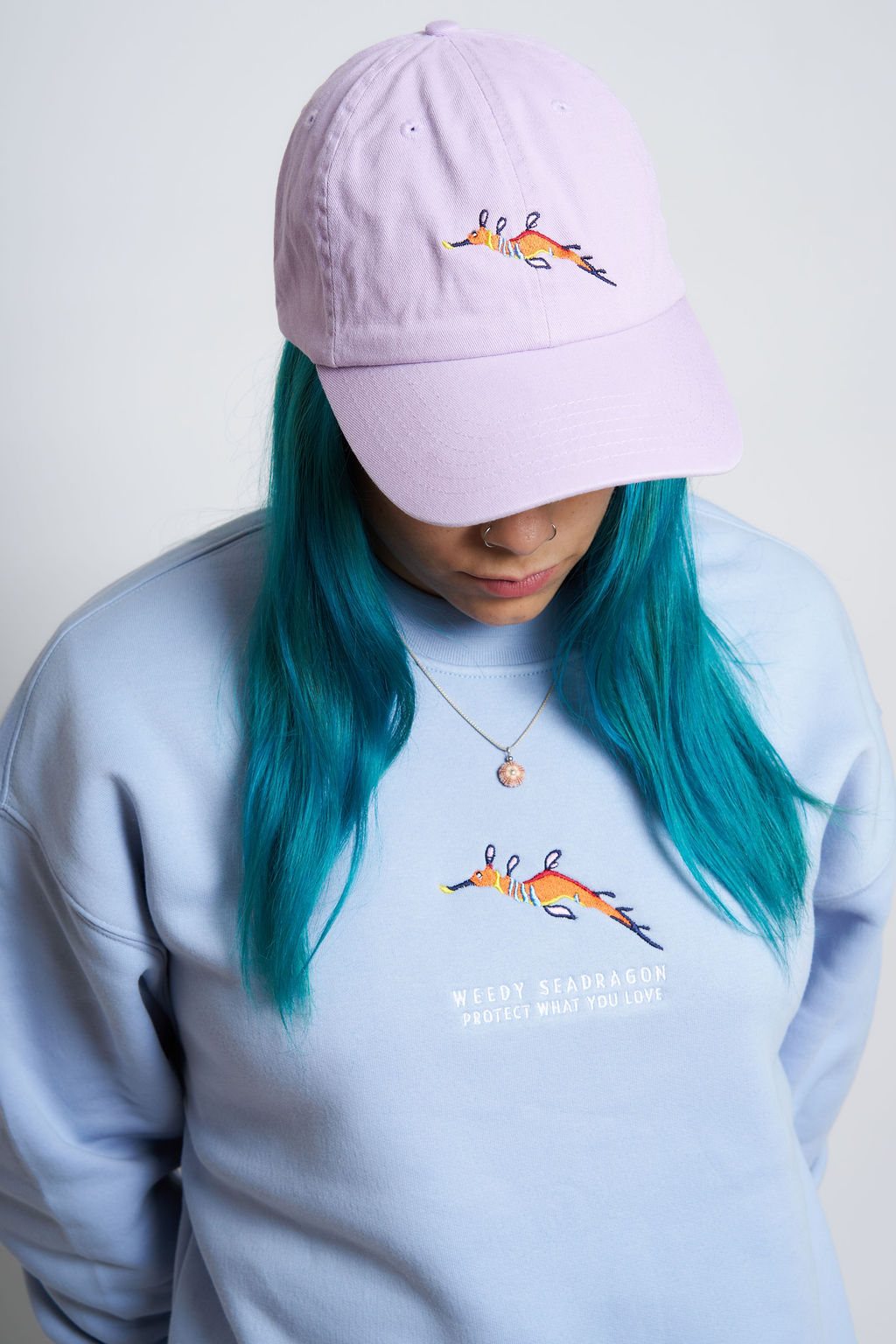 Protect What You Love Weedy Seadragon Curved Peak Cap — Tropical Purple, worn front view